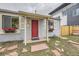 Charming front door with a vibrant red color, flanked by lovely windows and flower boxes at 1680 Simms St, Lakewood, CO 80215