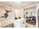 Modern kitchen with an island, stainless appliances, and open to the living room at 1680 Simms St, Lakewood, CO 80215