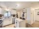 Bright kitchen with white cabinets, stainless steel appliances, and a center island at 1680 Simms St, Lakewood, CO 80215