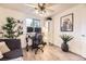 Stylish living room with ample light, featuring a modern sofa, unique decor, and a dedicated workspace at 1680 Simms St, Lakewood, CO 80215