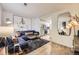 Modern living room with a comfortable blue sofa, stylish rug, and contemporary artwork at 1680 Simms St, Lakewood, CO 80215