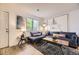 Cozy living room with large window, plush sofa, and decorative pillows at 1680 Simms St, Lakewood, CO 80215