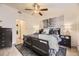 Comfortable main bedroom with a ceiling fan, light-toned walls, and a queen sized bed covered in stylish bedding at 1680 Simms St, Lakewood, CO 80215