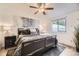 Comfortable main bedroom with a ceiling fan, light-toned walls, and a queen sized bed covered in stylish bedding at 1680 Simms St, Lakewood, CO 80215