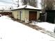 Detached garage with a partially damaged door at 645 S Perry St, Denver, CO 80219