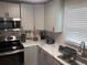 Modern kitchen with stainless steel appliances and white backsplash at 645 S Perry St, Denver, CO 80219