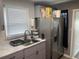 Modern kitchen with gray cabinets and marble countertops at 645 S Perry St, Denver, CO 80219