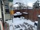 Small patio area with a snow covered grill and gazebo at 645 S Perry St, Denver, CO 80219