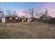 Backyard featuring mature trees and a well-maintained lawn, with a cozy patio area for outdoor enjoyment at 6903 W 52Nd Pl, Arvada, CO 80002