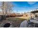 Expansive backyard with patio area, mature trees, and secure fencing, ideal for outdoor entertaining at 6903 W 52Nd Pl, Arvada, CO 80002