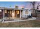 Spacious backyard featuring a covered patio with a hot tub, seating, a grill, and a lawn at 6903 W 52Nd Pl, Arvada, CO 80002