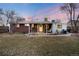 Brick home with covered patio and spacious backyard, creating a perfect setting for relaxation at 6903 W 52Nd Pl, Arvada, CO 80002