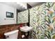 Bathroom featuring a floral-patterned shower curtain, a framed mirror, and tile flooring at 6903 W 52Nd Pl, Arvada, CO 80002