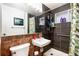 Cozy bathroom with tile, a framed mirror, shower, and a floral-patterned shower curtain at 6903 W 52Nd Pl, Arvada, CO 80002