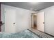 Neutral-toned bedroom with an open door, light walls, and carpet flooring, providing a calm living space at 6903 W 52Nd Pl, Arvada, CO 80002
