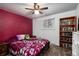 Bedroom with a bright window, ceiling fan, built-in bookcase, and neutral-toned walls at 6903 W 52Nd Pl, Arvada, CO 80002