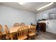 Bright dining room featuring natural wood table and chairs next to a window and an aquarium at 6903 W 52Nd Pl, Arvada, CO 80002
