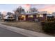 Picture of a single story red brick home with solar panels and small porch at 6903 W 52Nd Pl, Arvada, CO 80002