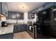Well-lit kitchen featuring granite countertops, stainless steel appliances, and updated cabinetry at 6903 W 52Nd Pl, Arvada, CO 80002