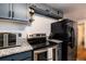 Well-lit kitchen featuring granite countertops, stainless steel appliances, and updated cabinetry at 6903 W 52Nd Pl, Arvada, CO 80002