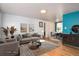 Staged living room with hardwood floors and an open floor plan to the dining area, perfect for entertaining at 6903 W 52Nd Pl, Arvada, CO 80002