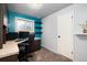 Home office setup featuring a built-in desk, computer setup, floating shelves, and ample workspace at 6903 W 52Nd Pl, Arvada, CO 80002