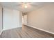 This bedroom features neutral paint, wood-look flooring, closet, and bathroom access at 2231 S Vaughn Way # 114B, Aurora, CO 80014