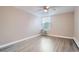 Bedroom featuring wood-look flooring, neutral paint, and a window with blinds at 2231 S Vaughn Way # 114B, Aurora, CO 80014