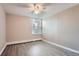 Bedroom features wood-look flooring, neutral paint, and a window with blinds at 2231 S Vaughn Way # 114B, Aurora, CO 80014