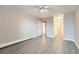 This bedroom has a ceiling fan, neutral paint, wood-look flooring and closet space at 2231 S Vaughn Way # 114B, Aurora, CO 80014