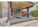 A welcoming building entrance with an awning, bench, and well-maintained landscaping for a comfortable arrival at 2231 S Vaughn Way # 114B, Aurora, CO 80014