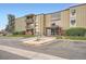Exterior of condo building with accessible entrance, landscaping, and parking at 2231 S Vaughn Way # 114B, Aurora, CO 80014
