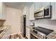 Modern kitchen features stainless steel appliances, wood floors, and bright lighting at 2231 S Vaughn Way # 114B, Aurora, CO 80014