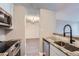Bright kitchen with stainless steel appliances, granite countertops, and sink with dark fixtures at 2231 S Vaughn Way # 114B, Aurora, CO 80014