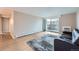 Spacious living room with wood floors, walk-out to balcony, and dark sofa on a patterned rug at 2231 S Vaughn Way # 114B, Aurora, CO 80014