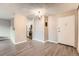 Open-concept dining/living room featuring modern lighting and wood floors connecting kitchen and hall at 2231 S Vaughn Way # 114B, Aurora, CO 80014