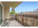 Private patio with a wooden fence, a table and chairs, and neighborhood views at 2231 S Vaughn Way # 114B, Aurora, CO 80014