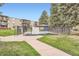 Gated community pool area featuring manicured lawns, mature trees, and resident access at 2231 S Vaughn Way # 114B, Aurora, CO 80014