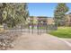 Gated community pool area featuring manicured lawns and mature trees for shade at 2231 S Vaughn Way # 114B, Aurora, CO 80014