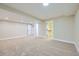 A carpeted basement area, featuring a walk-in closet for storage and multiple lighting features at 6596 Silverleaf Ave, Firestone, CO 80504