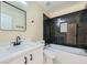 Modern bathroom with black and white marble tile, new fixtures, and tub shower at 6596 Silverleaf Ave, Firestone, CO 80504