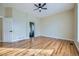 Spacious bedroom with hardwood floors, ceiling fan, and ensuite bathroom access at 6596 Silverleaf Ave, Firestone, CO 80504