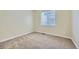 Cozy bedroom with neutral carpeting, a window, and fresh paint at 6596 Silverleaf Ave, Firestone, CO 80504