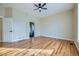 Spacious bedroom featuring hardwood floors, ceiling fan, and ample natural light at 6596 Silverleaf Ave, Firestone, CO 80504