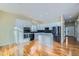 Modern kitchen features white cabinets, stainless steel appliances, and center island at 6596 Silverleaf Ave, Firestone, CO 80504