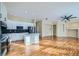Modern open-concept kitchen featuring white cabinets, stainless steel appliances, and a central island at 6596 Silverleaf Ave, Firestone, CO 80504
