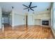 Bright living room featuring hardwood floors, a fireplace, and neutral paint at 6596 Silverleaf Ave, Firestone, CO 80504