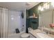 Well-lit bathroom with shower-tub combo, modern fixtures and decor at 2575 S Syracuse Way # M206, Denver, CO 80231