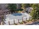 Aerial view of a community pool, enclosed by a fence and stone pillars, near a covered lounge area at 2575 S Syracuse Way # M206, Denver, CO 80231