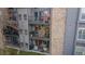 Exterior view of condo building featuring multiple levels with balconies and a stone accent wall at 2575 S Syracuse Way # M206, Denver, CO 80231